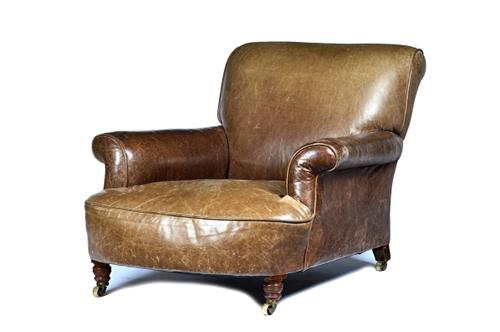 Howard & Sons, a Victorian later leather upholstered easy armchair with turned walnut supports, coasters stamped, back leg also stamped 179067398.  Il