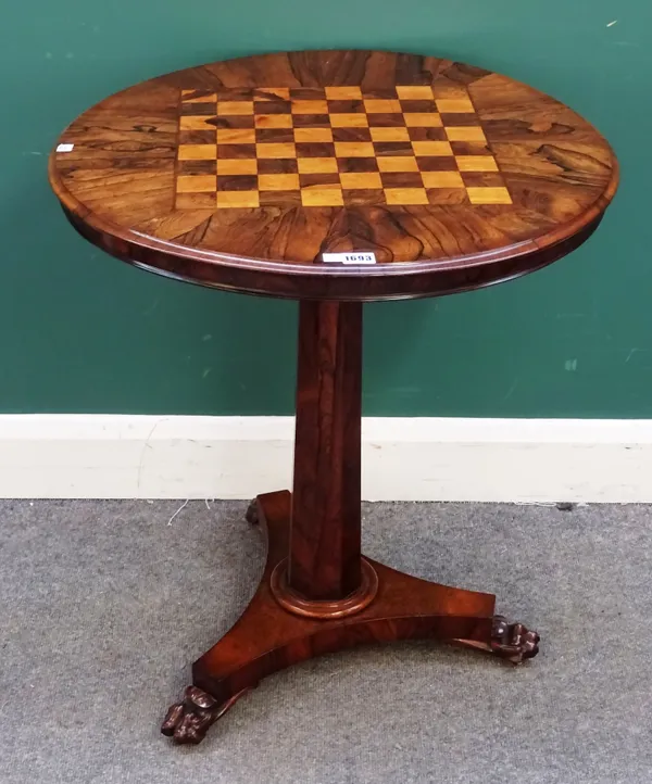 A William IV rosewood occasional table, the circular snap top with inset chessboard, on tapering octagonal column and three paw feet, 64cm wide x 73cm