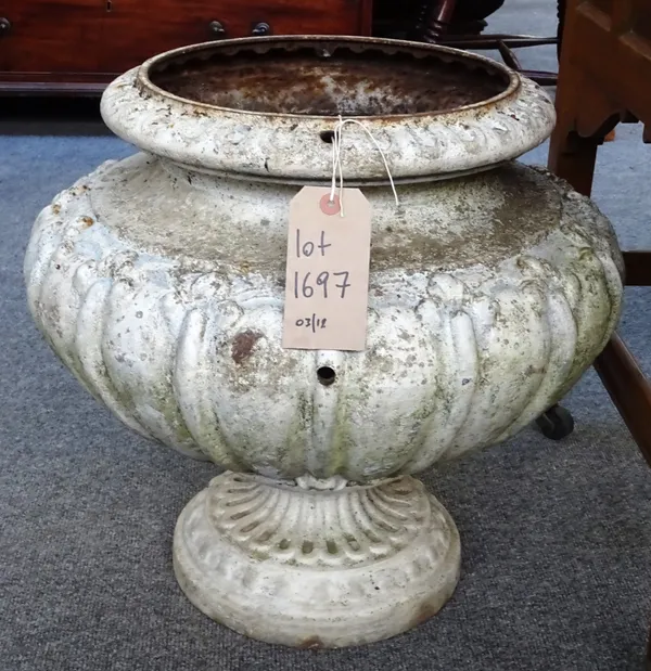 A pair of early 20th century white painted metal jardinieres, with gadrooned moulded bodies and circular base, 50cm wide x 48cm high.