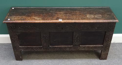 A 17th century oak coffer, the slab top of triple panel front, on stile feet, 122cm wide x 58cm high x 37cm deep.
