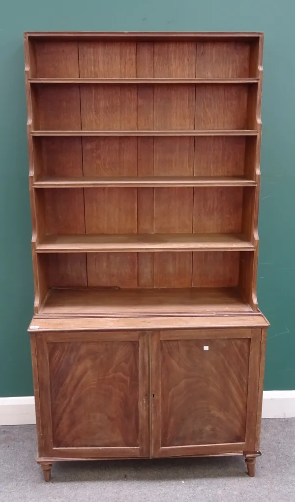 A 19th century mahogany bookcase cabinet, the five tier waterfall bookcase top over pair of cupboards, 93cm wide x 180cm high x 42cm deep.