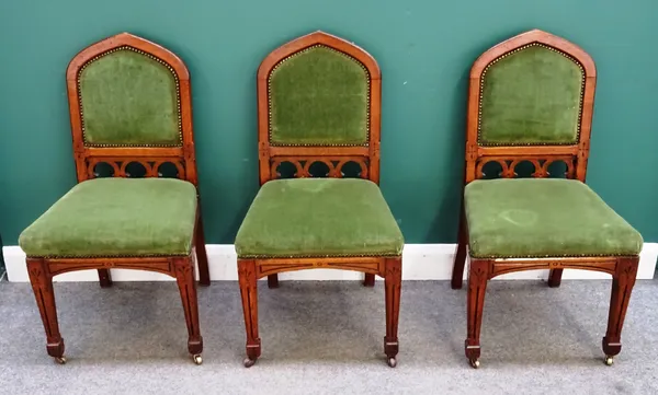 A set of six Victorian oak framed Gothic Revival dining chairs, with pointed arch back on tapering channelled square supports. (6)