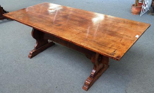 A 17th century style oak refectory table, on baluster silhouette trestle end standards, united by a stretcher, 83cm wide x 180cm long x 76cm high.