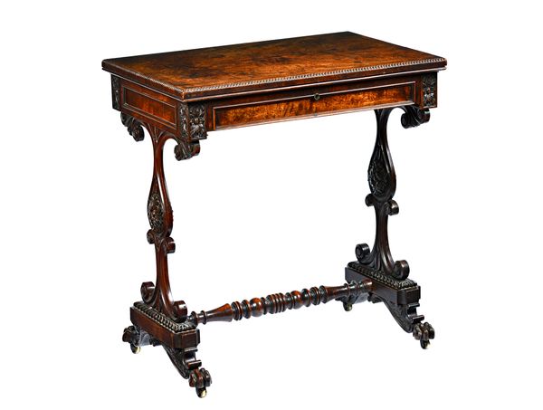 A Victorian mahogany writing table, the rectangular top over fitted frieze drawer, on shaped trestle end standards and lion's paw feet, 77cm wide x 51