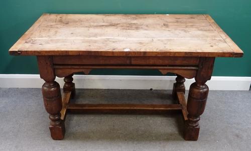 A 17th century and later oak centre table, the rectangular plank top on four cup and cover supports, waited by H frame stretcher, 75cm wide x 138cm lo
