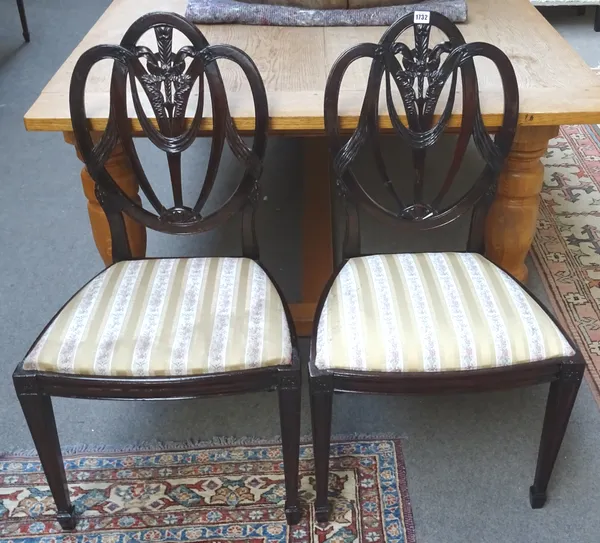 A set of seventeen Hepplewhite style mahogany dining chairs, with ribbon and swag interlaced triple back, over bow seat, on tapering square supports,