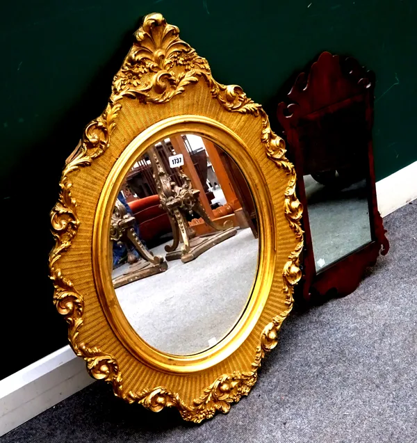 An early 20th century gilt framed wall mirror, with shaped oval frame, 65cm wide x 90cm high, together with an 18th century style walnut fret cut pier