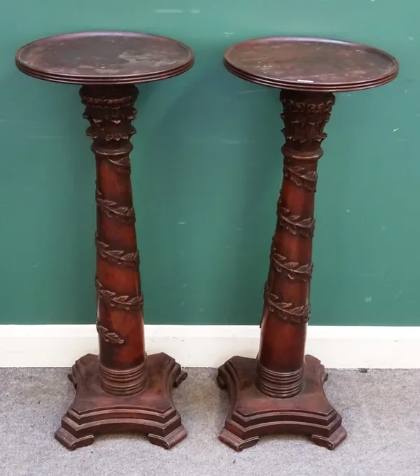 A pair of 18th century style carved hardwood jardiniere stands, each with dished circular top and floral chased column, on lozenge shaped platform, 37