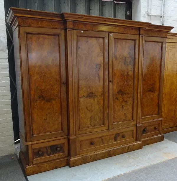 A Victorian figured walnut breakfront compactum wardrobe, on plinth base, 205cm wide x 225cm high x 74cm deep.