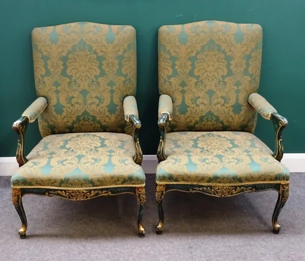 A pair of George III style green painted parcel gilt open armchairs, with serpentine seat and scroll supports, 72cm wide x 107cm high.