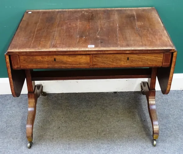 A Regency pollard oak banded rosewood sofa table, with a pair of frieze drawers on four downswept supports, 89cm wide across x 154cm across open x 69c