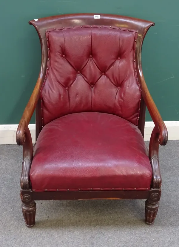 A George IV mahogany framed library armchair, the swept top with later button upholstered back and seat, scroll over arms and short reeded supports, 6