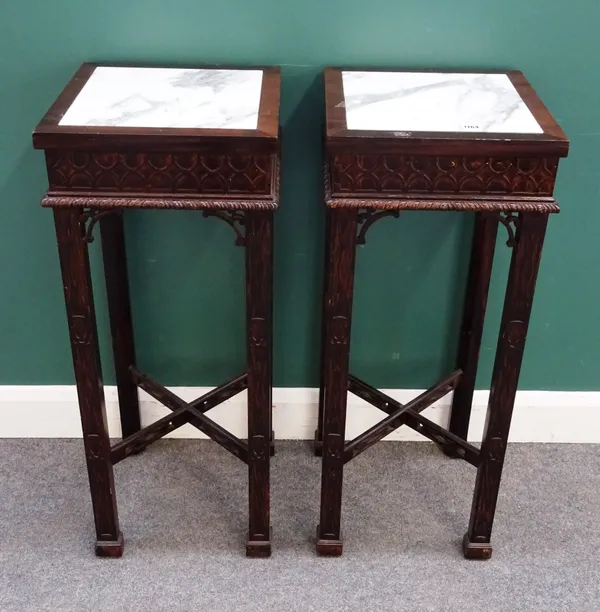 A pair of George II style mahogany jardiniere stands, each with square marble inset tops on four block supports, united by 'X' stretcher, both with bl