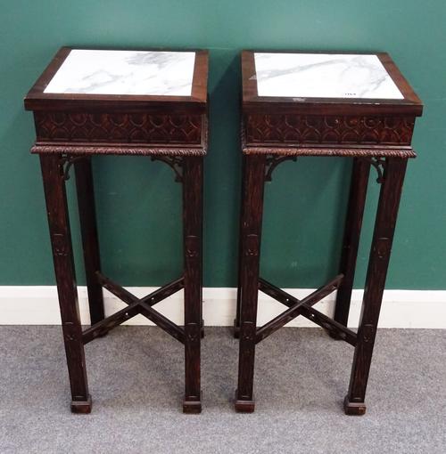 A pair of George II style mahogany jardiniere stands, each with square marble inset tops on four block supports, united by 'X' stretcher, both with bl
