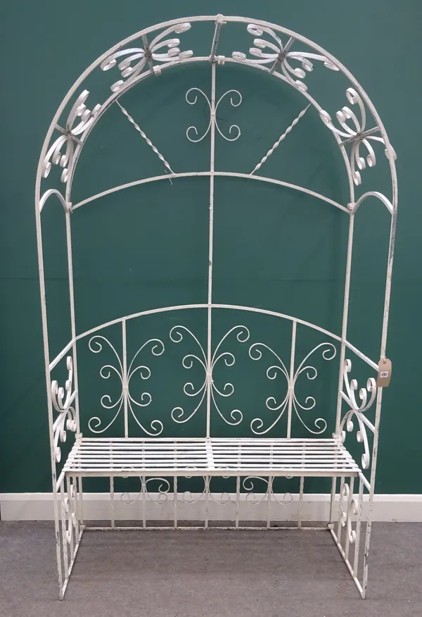 A 20th century white painted wrought iron garden lovers' seat, with integral arch canopy, 126cm wide x 214cm high x 63cm deep.