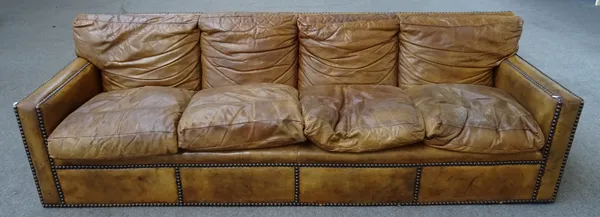 A 20th century brown leather upholstered brass studded four seat sofa, 258cm wide x 80cm high.