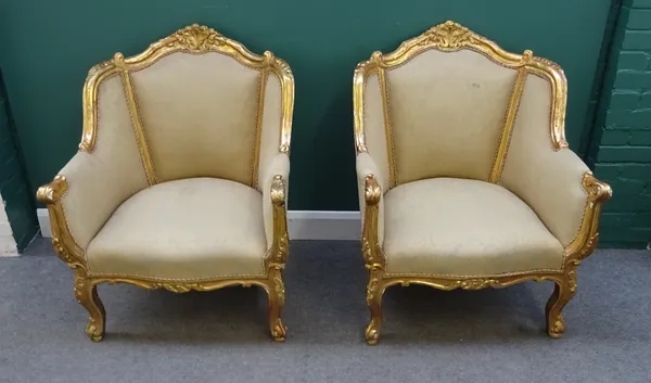 A pair of 18th century style gilt framed tub back armchairs, with shell carved crest and serpentine seat on scroll supports, 77cm wide x 99cm high.