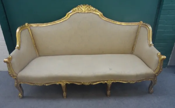 An 18th century style gilt framed three seat sofa, with shell carved crest and serpentine seat, on scroll supports, 199cm wide x 114m high.