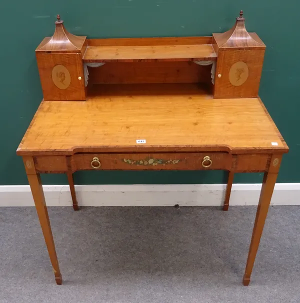 A 20th century painted satinwood and rosewood lady's writing table, in the late George III style, the raised back with profile painted small cupboards