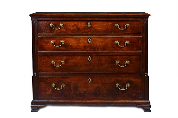 A George III mahogany chest with four long graduated drawers flanked by fluted corners on ogee bracket feet, 101cm wide x 84cm high x 46cm deep.  Illu