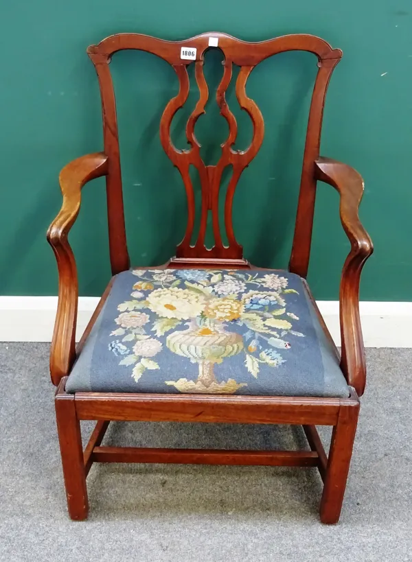 A mid-18th century mahogany open armchair, the pierced splat back on canted square supports.