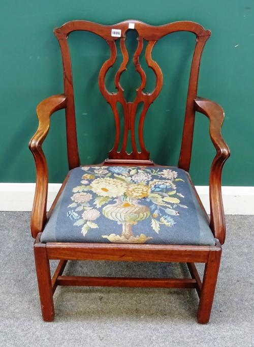 A mid-18th century mahogany open armchair, the pierced splat back on canted square supports.