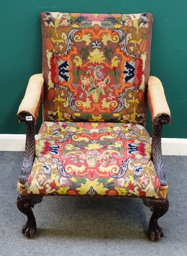 A George II style carved mahogany framed Gainsborough armchair, the floral upholstered back, arms and seat within heavily carved floral frame, leaf ca