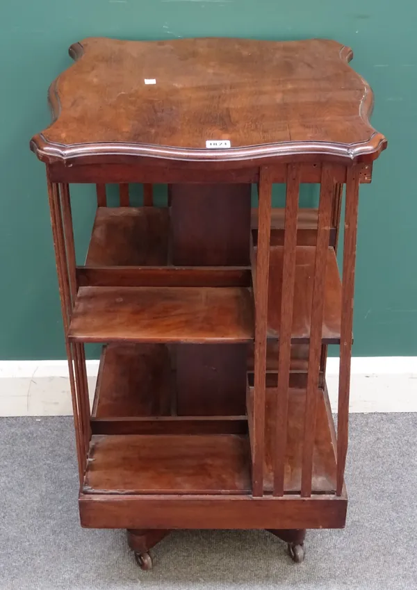 A late 19th century rosewood revolving bookcase, the top with serpentine outline, 50cm wide x 88cm high.