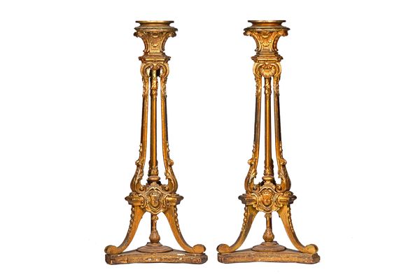 A pair of 18th century style gilt torchère stands, each with three open scroll columns and three downswept supports, on platform undertier, 143cm high