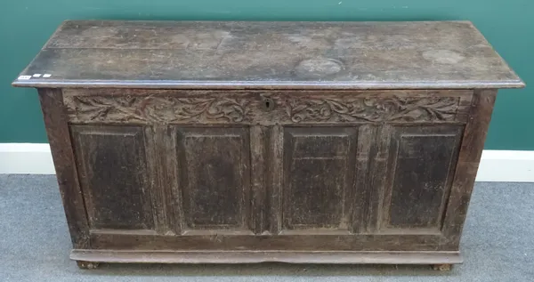 An 18th century oak coffer, the double plank top over four panel front, 146cm wide x 72cm high x 52cm deep.