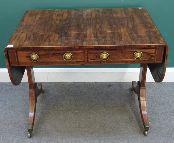 A Regency rosewood and box strung sofa table, the twin drop leaf top above a pair of drawers opposed by dummy drawers, dual standard end supports, out