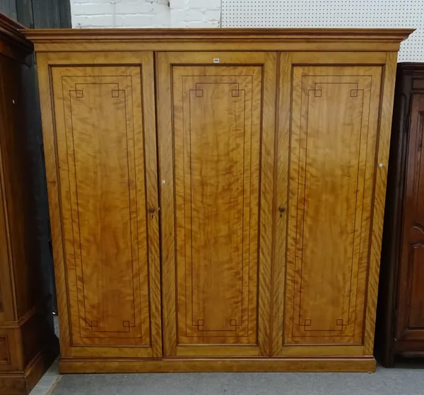 A Victorian triple section inlaid satin birch wardrobe, on plinth base, 228cm wide x 218cm high x 61cm deep.