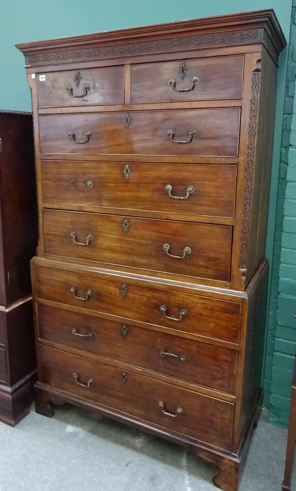 A George III mahogany chest on chest, of two short over six long graduated drawers, with blind fret carved decoration, on bracket feet, 110cm wide x 1