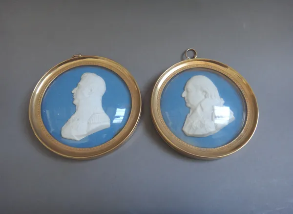 Two Sèvres circular biscuit blue and white portrait plaques, 19th century, both marked to the truncation, the first impressed SEVRES depicting Louis X