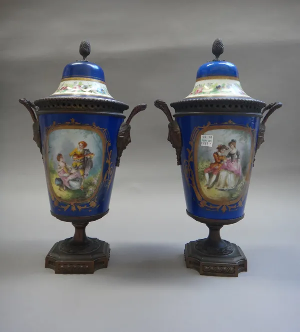 A pair of French Sèvres style porcelain and gilt-metal mounted vases and covers, late 19th century, each decorated with a gallant and companion agains