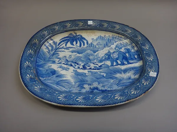 A J. & R. Riley blue and white printed meat dish, circa 1820, printed with an `Eastern Street Scene', blue printed mark, 49cm. wide; also a blue and w