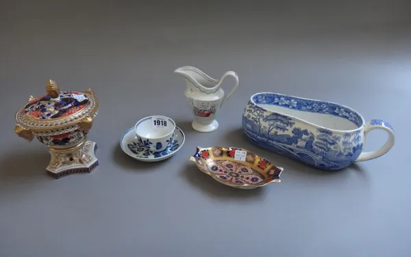 A Worcester porcelain blue and white tea bowl and saucer, circa 1770, printed with `The Three Flowers' pattern, together with an 18th century Newhall