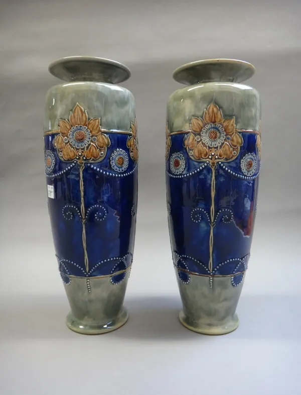 A pair of Royal Doulton stoneware vases, of foliate Art Nouveau design, 35.5cm high, a smaller pair of Royal Doulton stoneware vases, and a pair of Do