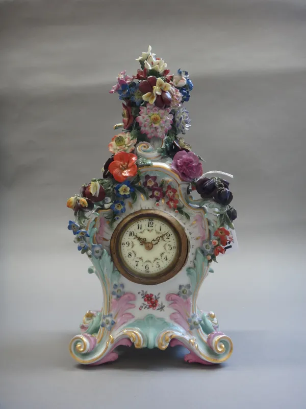 A Volkstedt porcelain mantel clock, early 20th century, encrusted with flowers against a gilt scroll body, on four feet, with a single train movement,