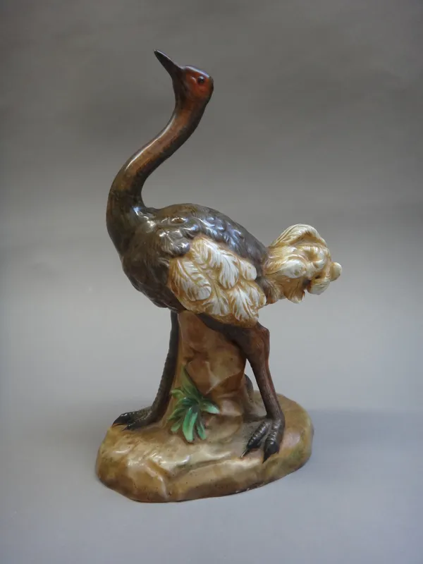 A pair of Volkstedt porcelain ostriches, 22cm high, a pair of Chinese pottery cranes, 41.5cm high, and a Japanese pottery figural group of fighting sh