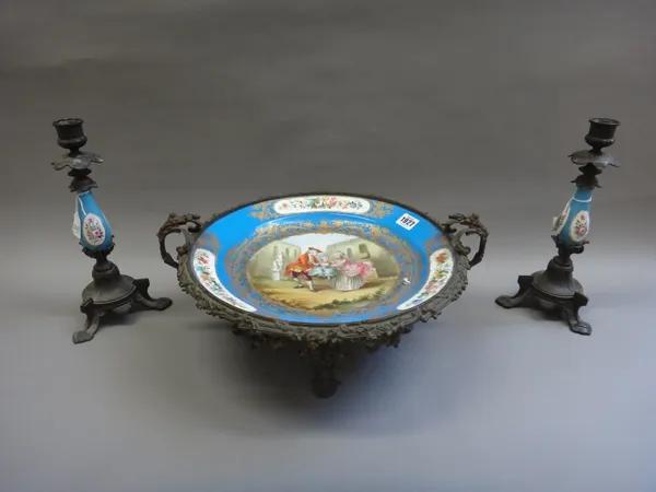 A Sèvres style porcelain and gilt metal mounted tazza, circa 1900, the porcelain decorated with a family group within a wide blue gilt blue border, en