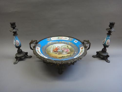 A Sèvres style porcelain and gilt metal mounted tazza, circa 1900, the porcelain decorated with a family group within a wide blue gilt blue border, en