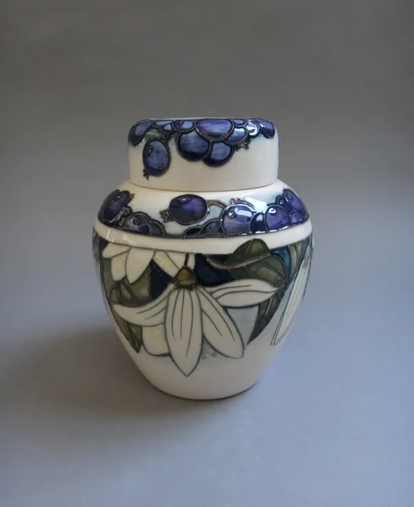 A Moorcroft ginger jar and cover, 'Juneberry' by Anji Davenport circa 2000, tube line decorated with leaves and berries against an ivory ground, impre