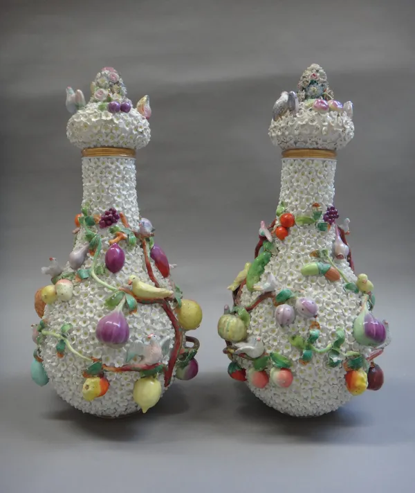 A pair of French porcelain schneeballen vases and covers in Meissen style, late 19th century, each applied in high relief with birds in fruiting branc