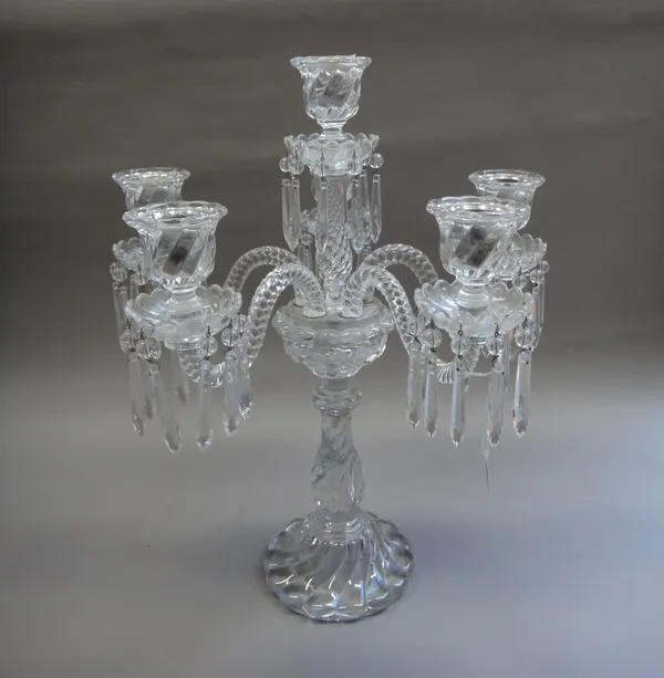 A French crystal six branch candelabra, 20th century, the spiral twist baluster stem issuing six spiral twist branches, each sconce hung with lustre d