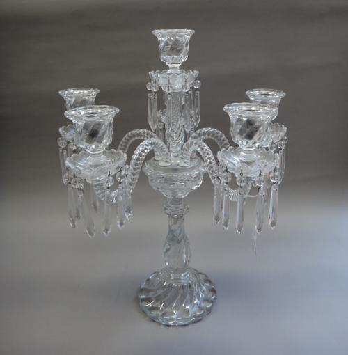 A French crystal six branch candelabra, 20th century, the spiral twist baluster stem issuing six spiral twist branches, each sconce hung with lustre d