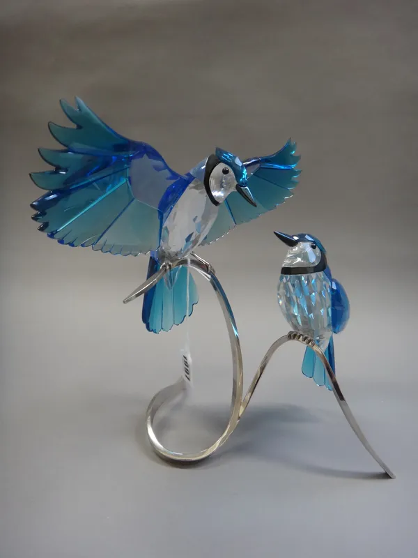 A Swarovski crystal 'Blue Jays' centrepiece, modelled with two birds atop a silvered metal branch, 27.5cm high.