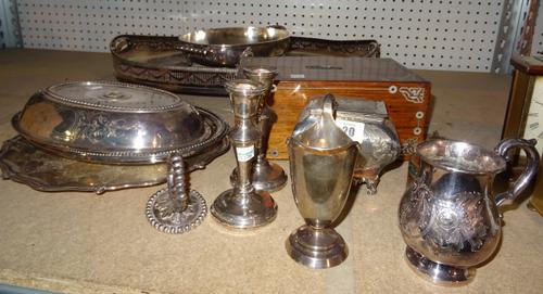 Silver and silver plated wares, including; a helmet shaped milk jug, hallmarked, a pair of candlesticks, hallmarked, a large oval galleried tray salve