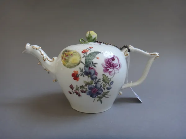 A Meissen porcelain teapot, circa. 1760, foliate decorated with a basket weave moulded top and figural spout, blue crossed swords mark. 11cm high.