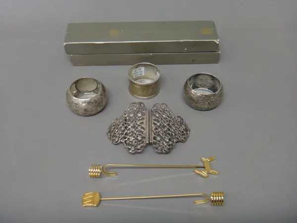 Silver, comprising; a pair of Victorian napkin rings, having engraved decoration, Birmingham 1887, another napkin ring and a two piece waist belt buck